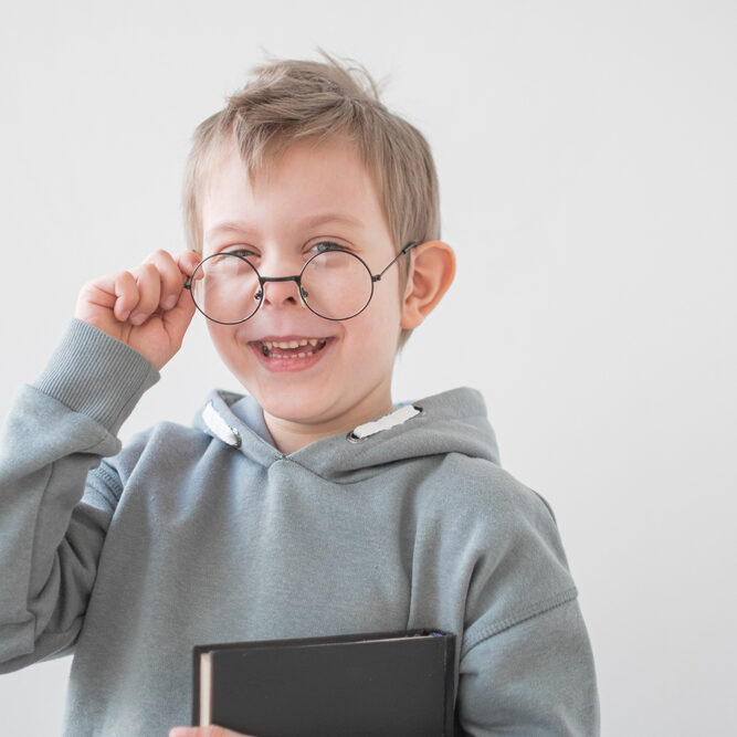 Cheerful,Little,Preschooler,Boy,In,Glasses,And,Neutral,Clothes,With