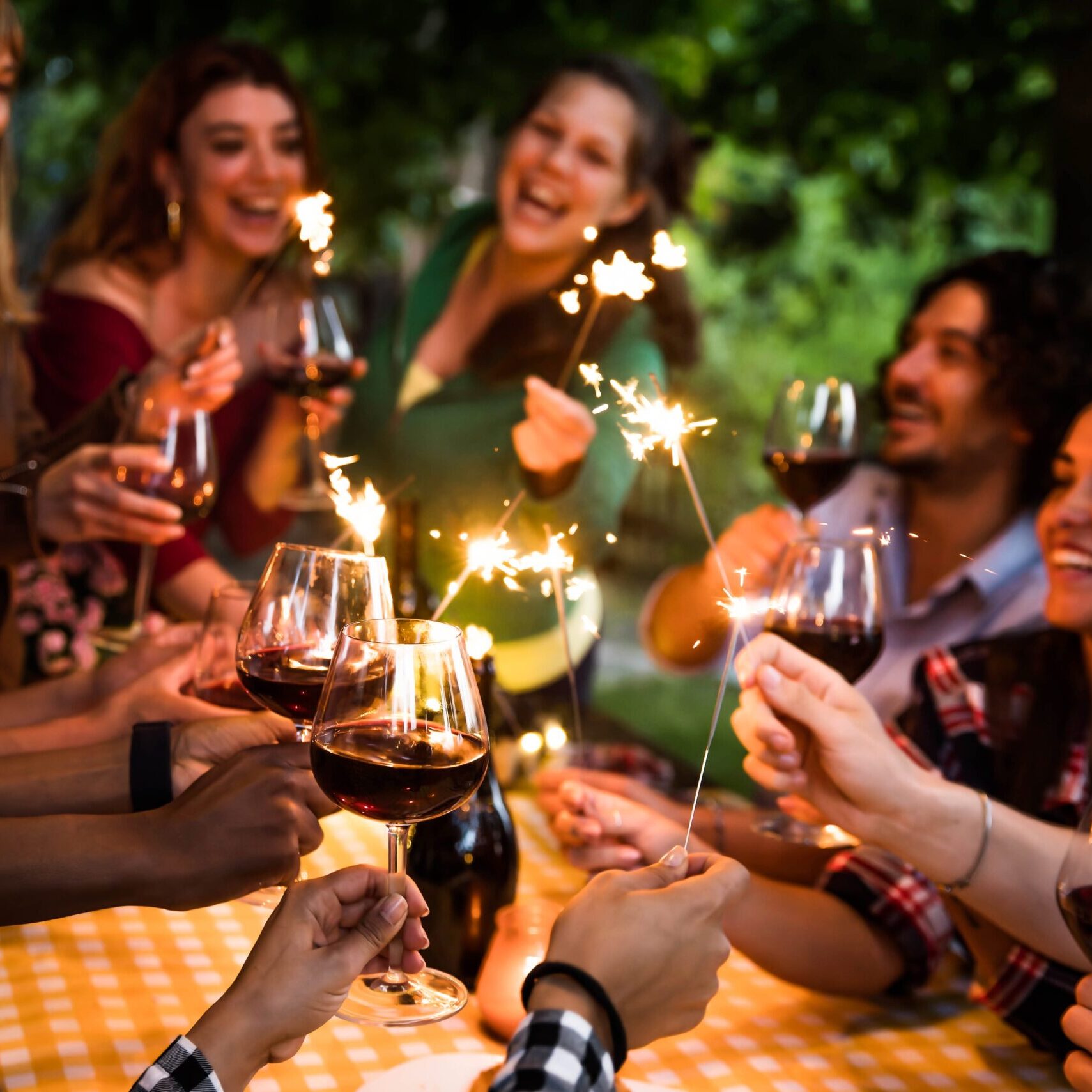 Happy,Family,Celebrating,With,Fireworks,At,Barbecue,Backyard,Party,-