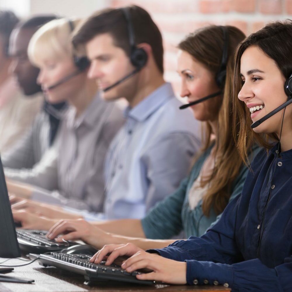 Positive,Female,Customer,Services,Agent,With,Headset,Working,In,A